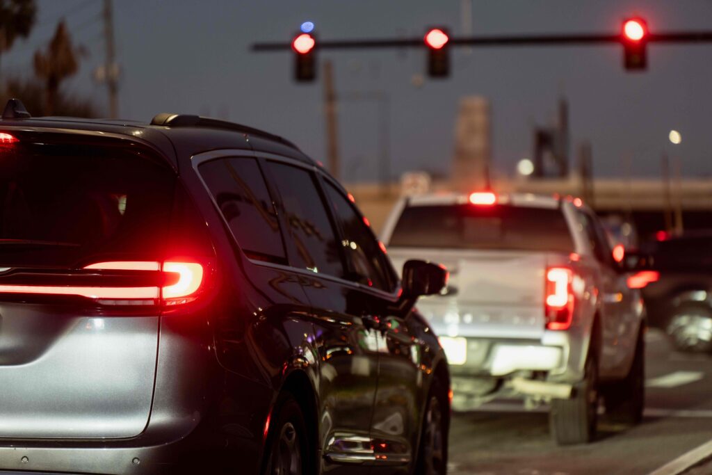 Cars stopped at a red light with brake lights on, a common setup for rear-end collision fault disputes in Louisiana