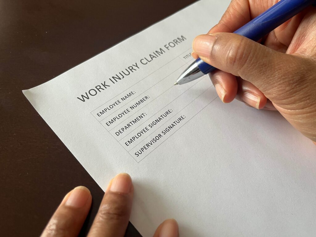 Workers compensation claim form being completed at a desk
