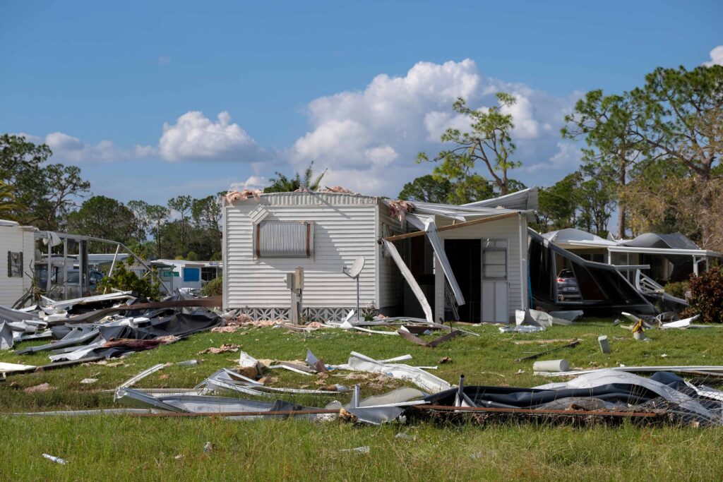 Homeowner photographing storm damage for an insurance claim